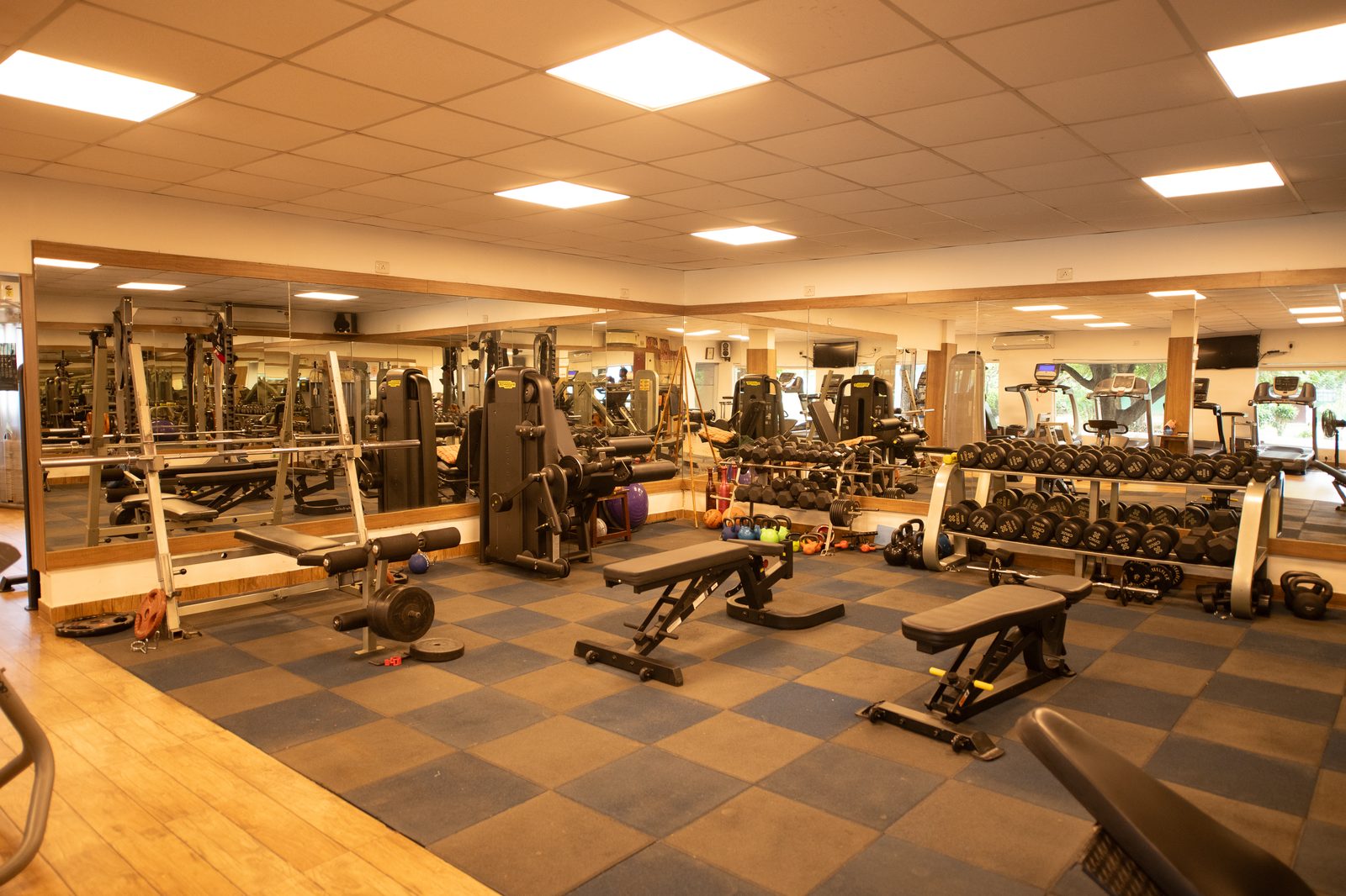 Free-weight floor and strength stations in the Madras Gymkhana Club gymnasium