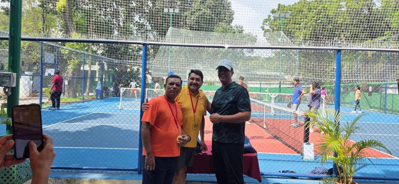 Medal winners posing on the pickleball courts during a daytime tournament at Madras Gymkhana Club