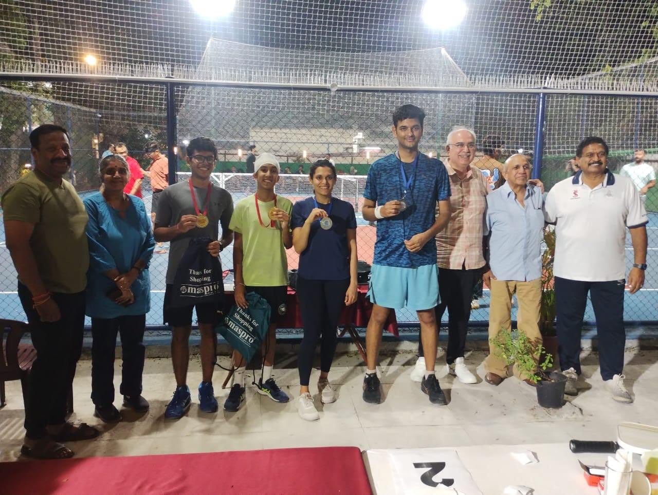 Players and officials at an evening pickleball tournament under lights at Madras Gymkhana Club